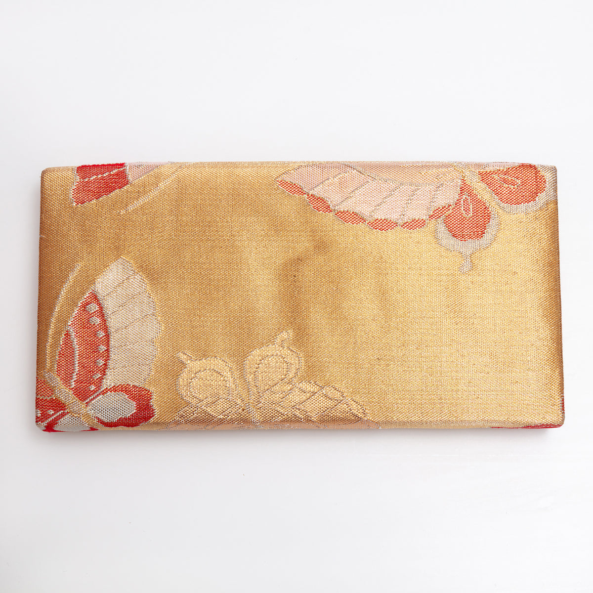 Metallic gold silk reverse of vintage Japanese envelope clutch showing slight dent