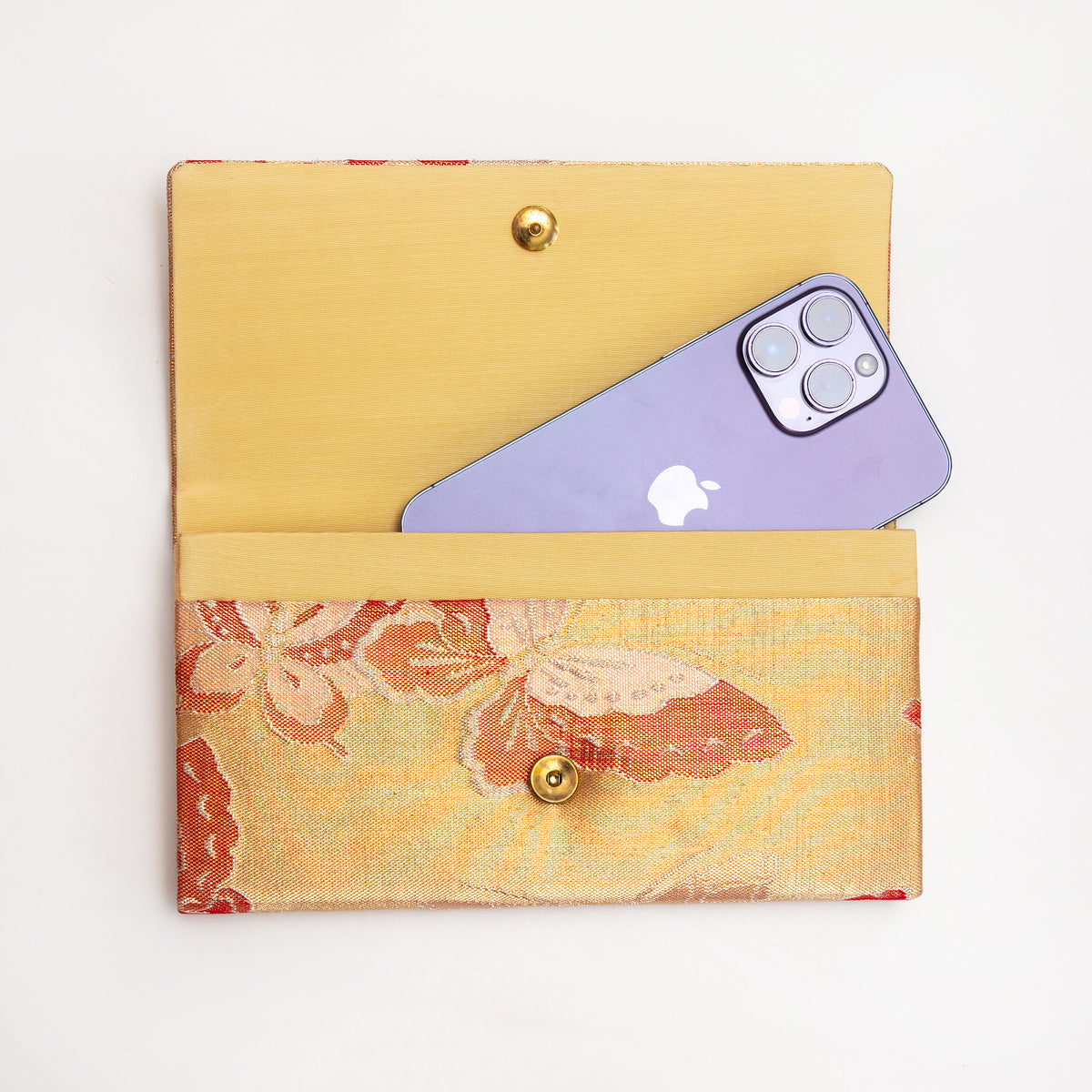 Gold butterfly Japanese silk clutch shown with iPhone 14 Pro Max for scale