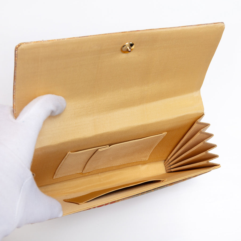 Butter silk interior with two pockets inside vintage Japanese clutch