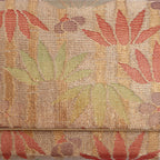 Close-up of bamboo, flowers and checkerboard-patterned metallic Japanese kimono silk