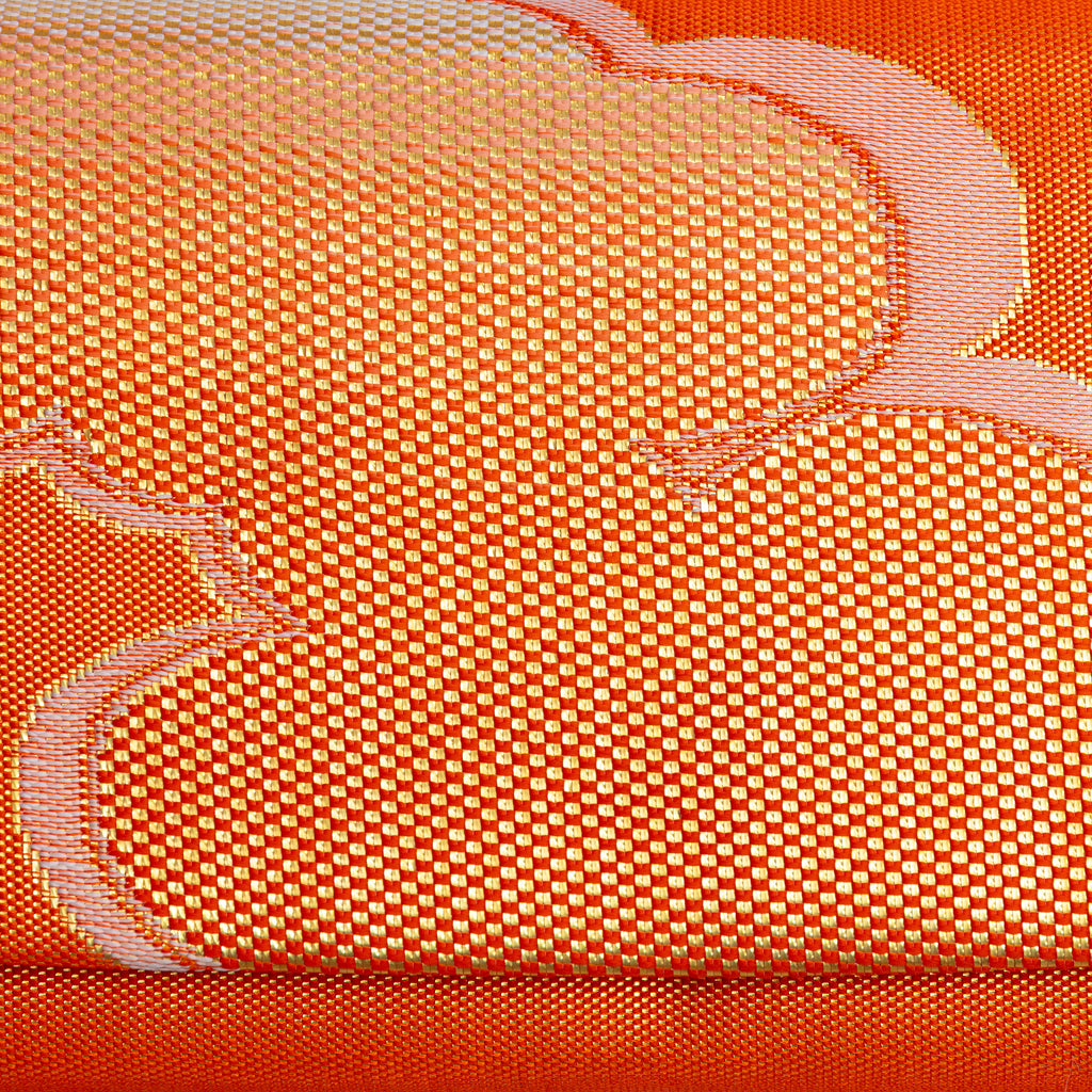 Close-up of single gold cloud motif woven into metallic orange kimono silk