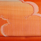 Close-up of single gold cloud motif woven into metallic orange kimono silk