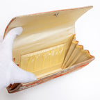 Cream silk interior with two pockets inside, one with gold trim, vintage Japanese envelope clutch, age spots on concertina edge interior.