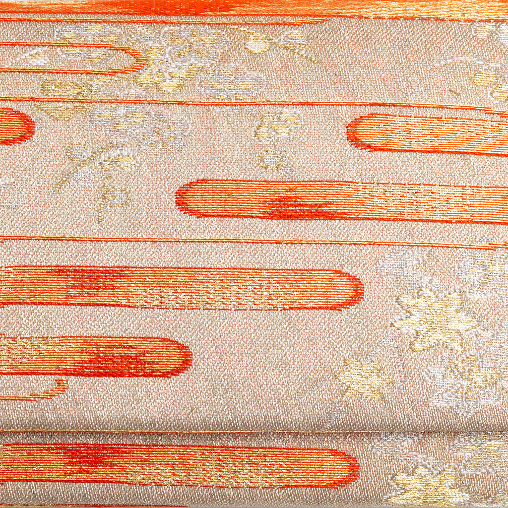 Close-up of orange kasumi mist and delicate gold floral motifs woven into pale gold vintage kimono silk clutch bag