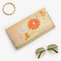 Gold Japanese silk foldover clutch with pale mint green accent and chrysanthemum motif, shown in styled flatlay