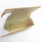 Cream silk interior with two pockets inside vintage Japanese foldover clutch, some age spots