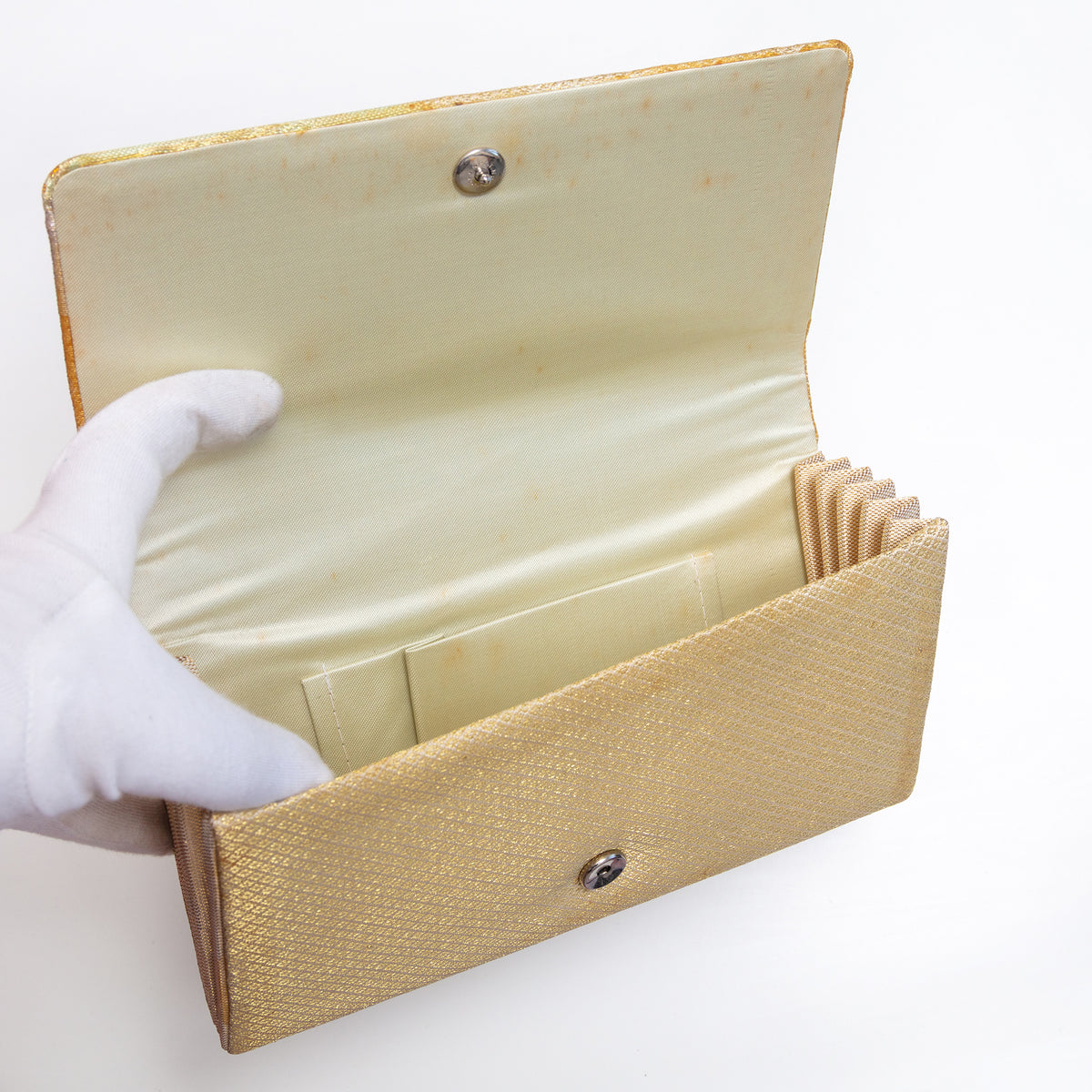 Cream silk interior with two pockets inside vintage Japanese foldover clutch, age spots inside flap.