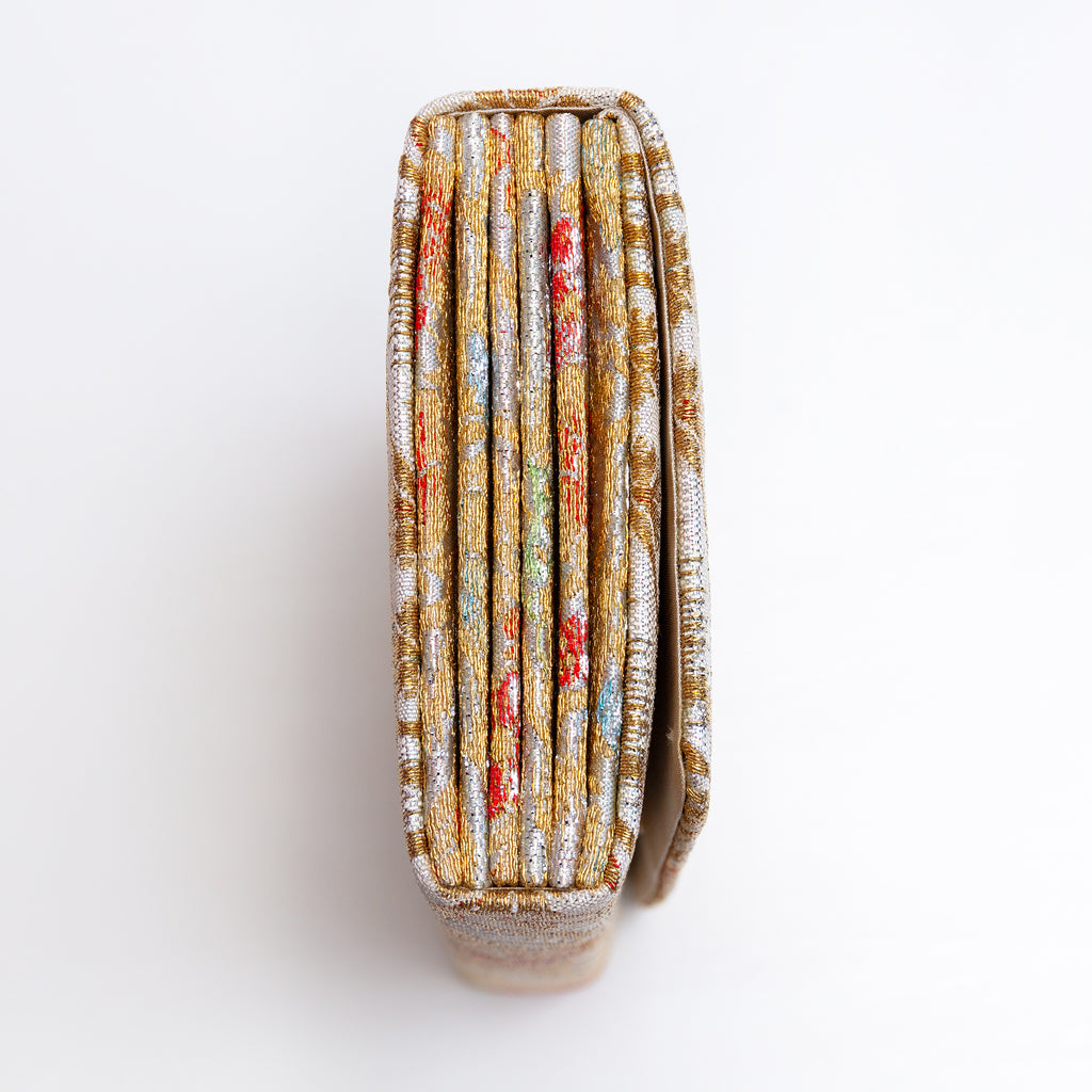 Side view of silver and gold Japanese silk envelope clutch showing concertina construction