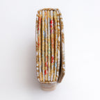 Side view of silver and gold Japanese silk envelope clutch showing concertina construction
