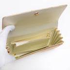 Cream silk interior with three pockets inside vintage Japanese foldover clutch, mark in base interior.
