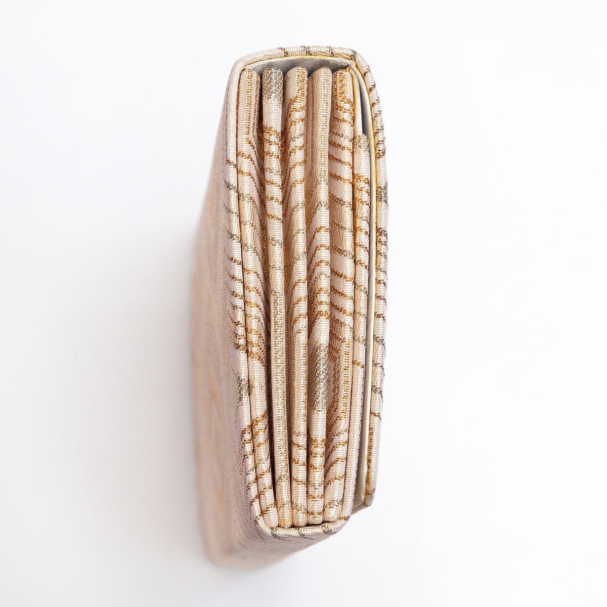 Side view of pale gold Japanese silk foldover clutch