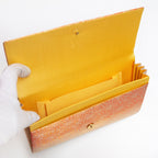Butter silk interior with two pockets and two compartments inside vintage Japanese foldover clutch