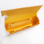 Butter silk interior with two pockets and two compartments inside vintage Japanese foldover clutch