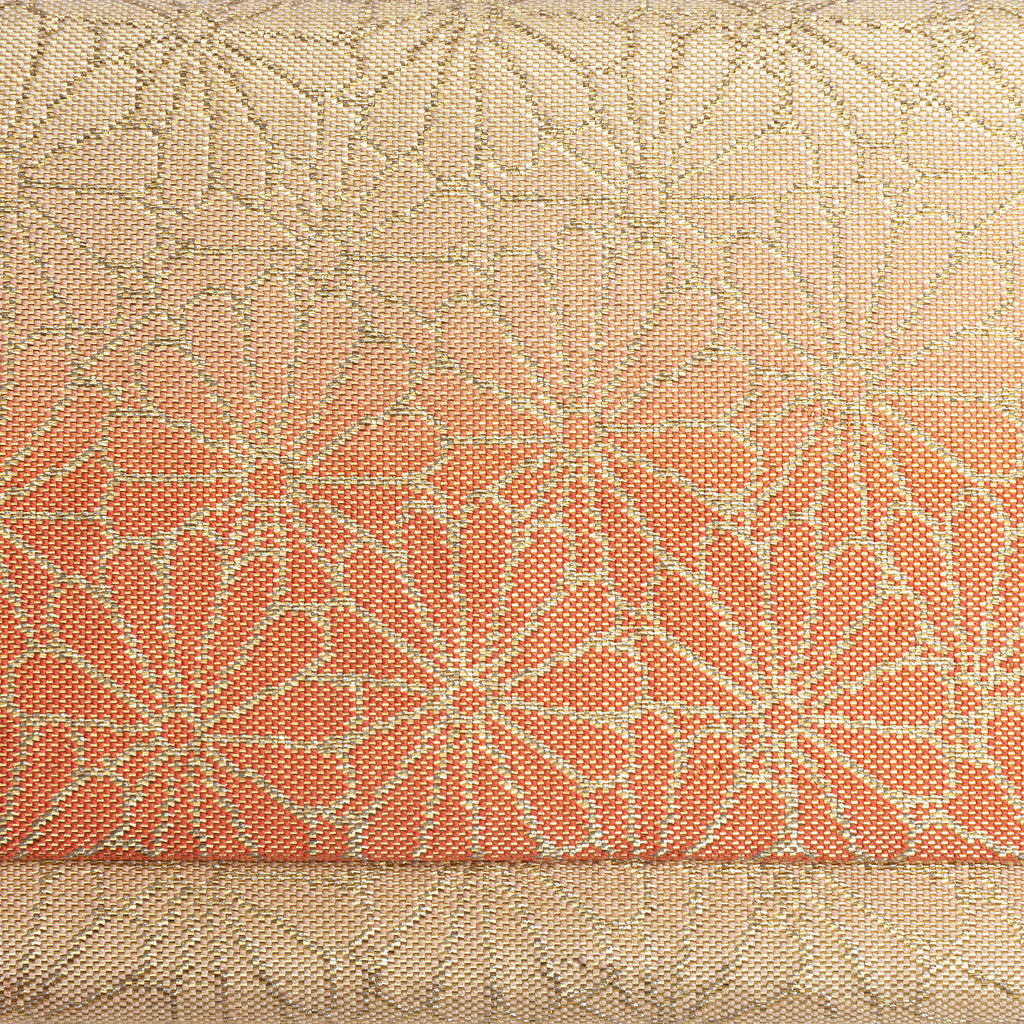 Close-up of orange-to-gold ombré kimono silk woven with Kiku chrysanthemum motifs