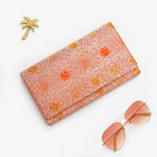 Peach and silver Japanese kimono silk envelope clutch with hypnotic abstract geometric design, shown in styled flatlay
