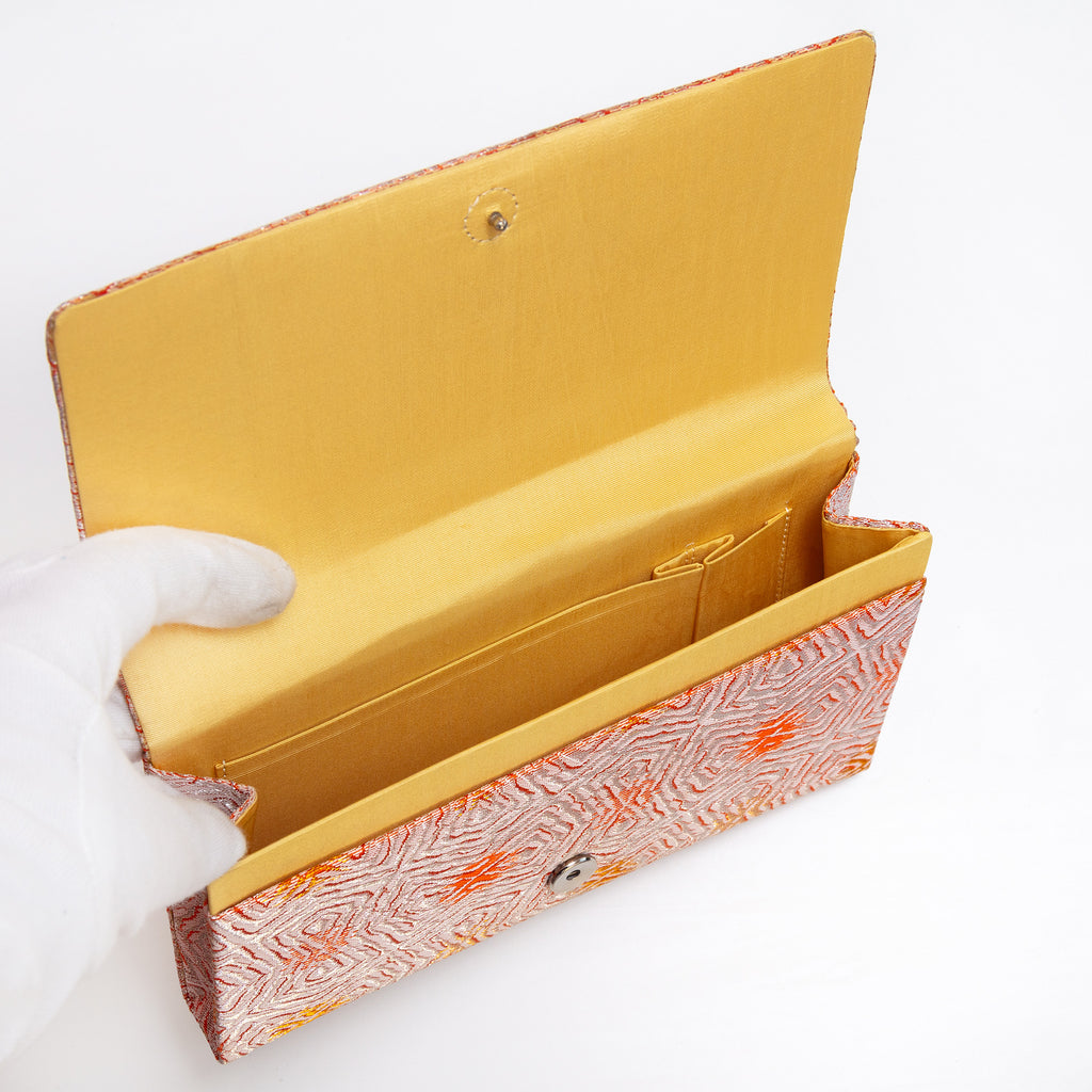 Butter silk interior with two pockets and two compartments inside vintage Japanese envelope clutch