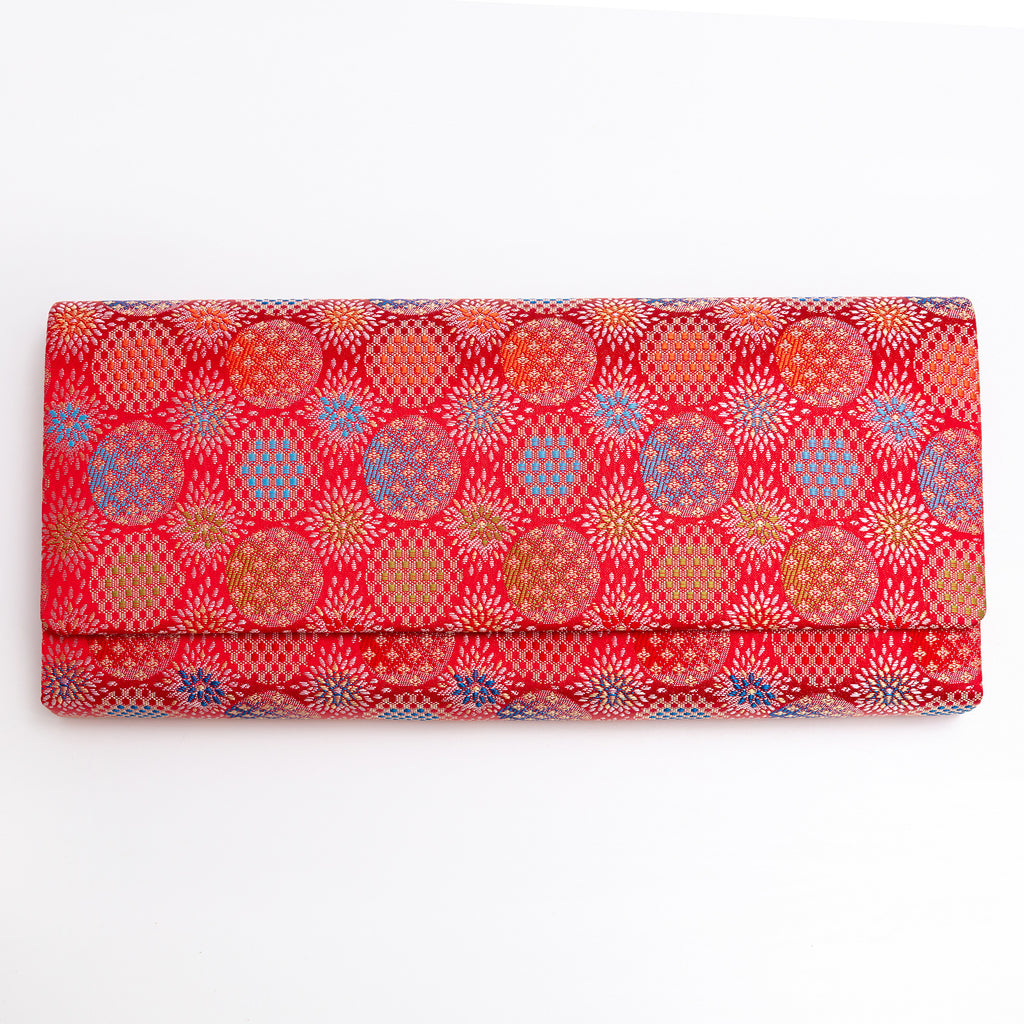 Vermilion red vintage Japanese silk envelope clutch with glowing circular and starburst motifs