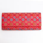 Vermilion red vintage Japanese silk envelope clutch with glowing circular and starburst motifs