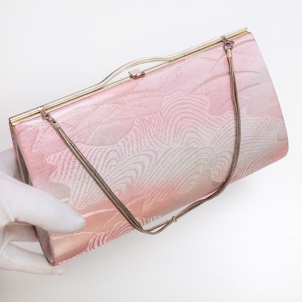 Pink silver Japanese kimono silk clutch bag shown at an angle