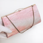 Pink silver Japanese kimono silk clutch bag shown at an angle