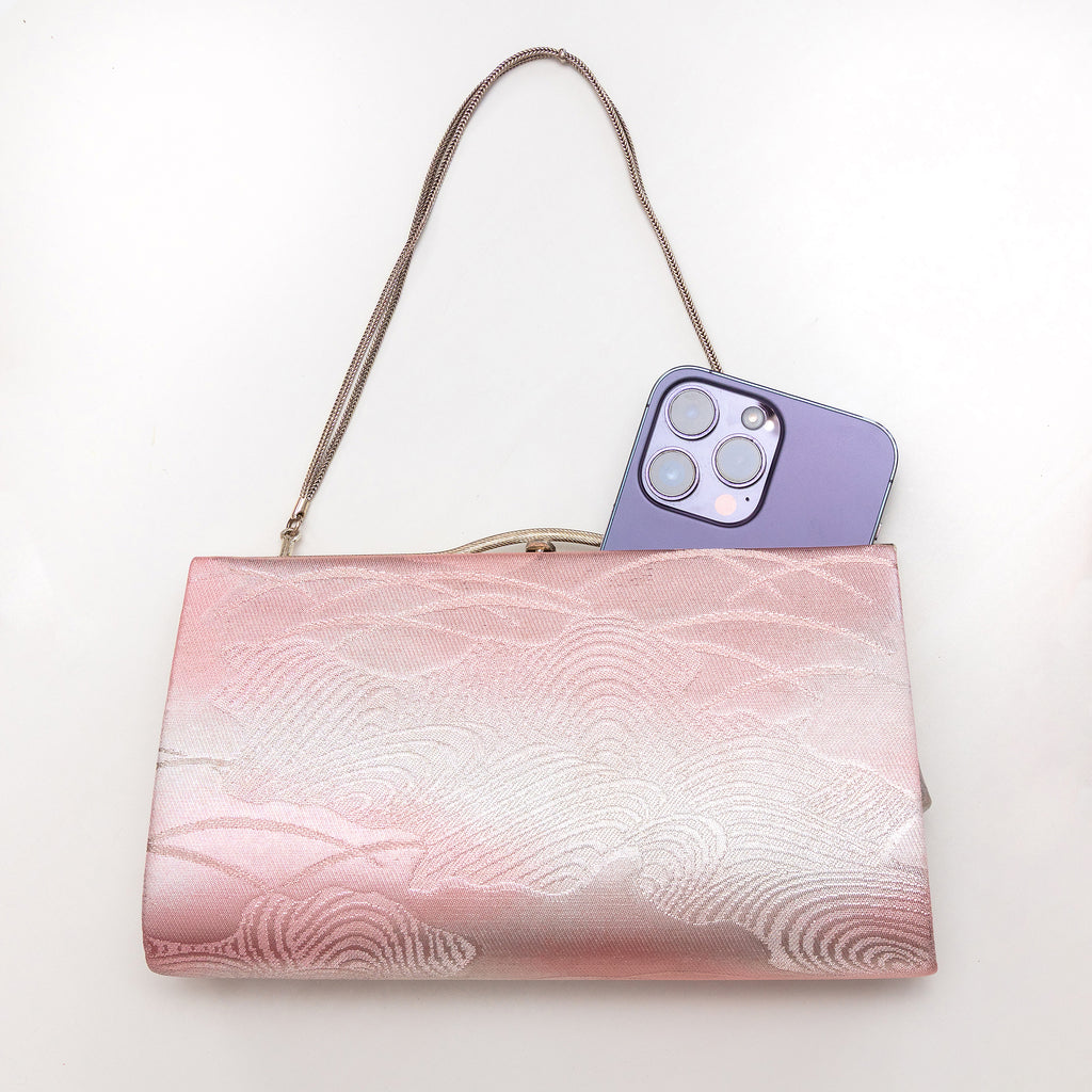 Vintage Japanese clutch bag shown with iPhone 14 Pro Max for scale