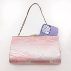 Vintage Japanese clutch bag shown with iPhone 14 Pro Max for scale