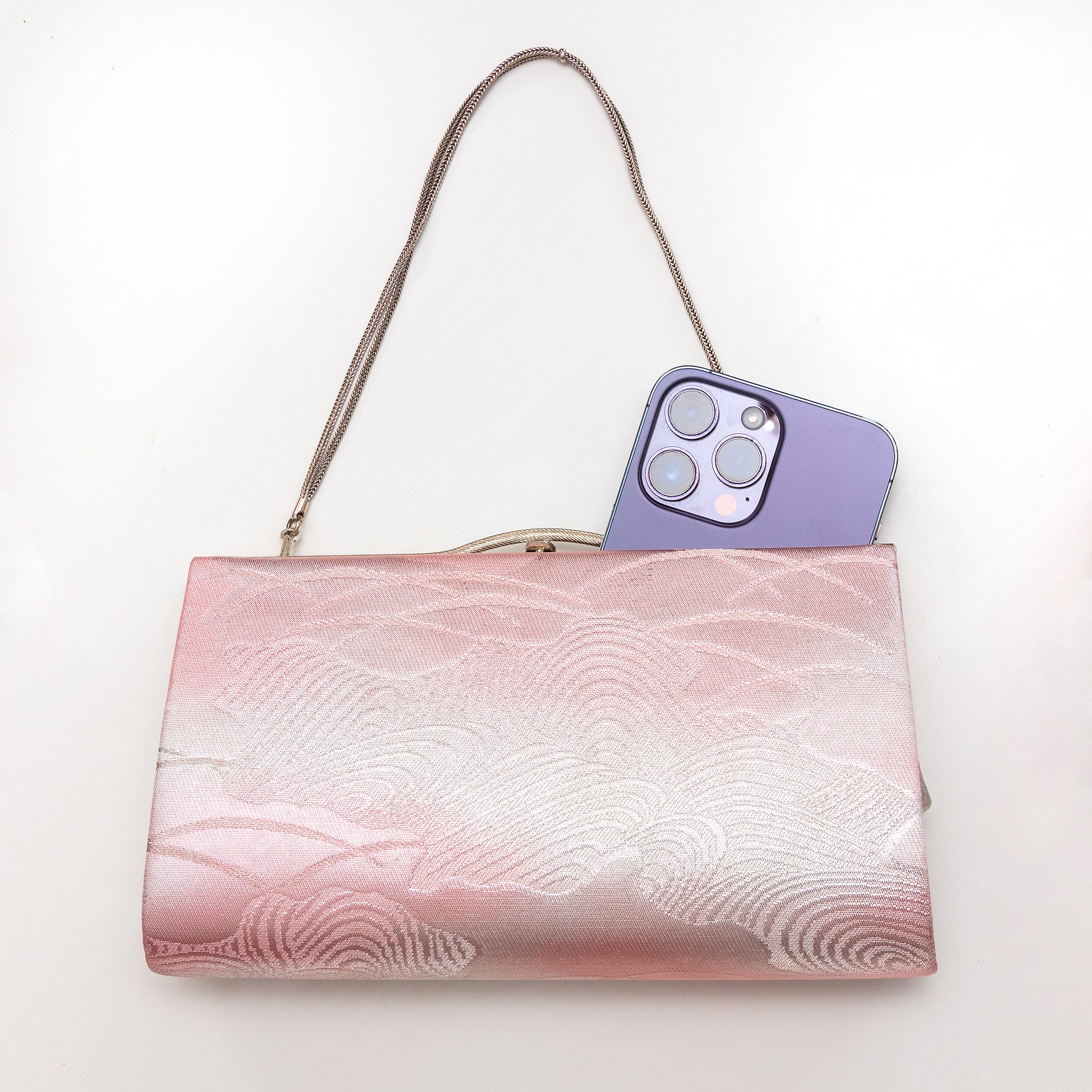 Vintage Japanese clutch bag shown with iPhone 14 Pro Max for scale