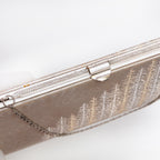 Decorative silver-tone filigree frame and clasp on vintage Japanese clutch