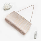 Pale gold and silver Japanese kimono silk clutch bag  with trees pattern in a styled flatlay on white.