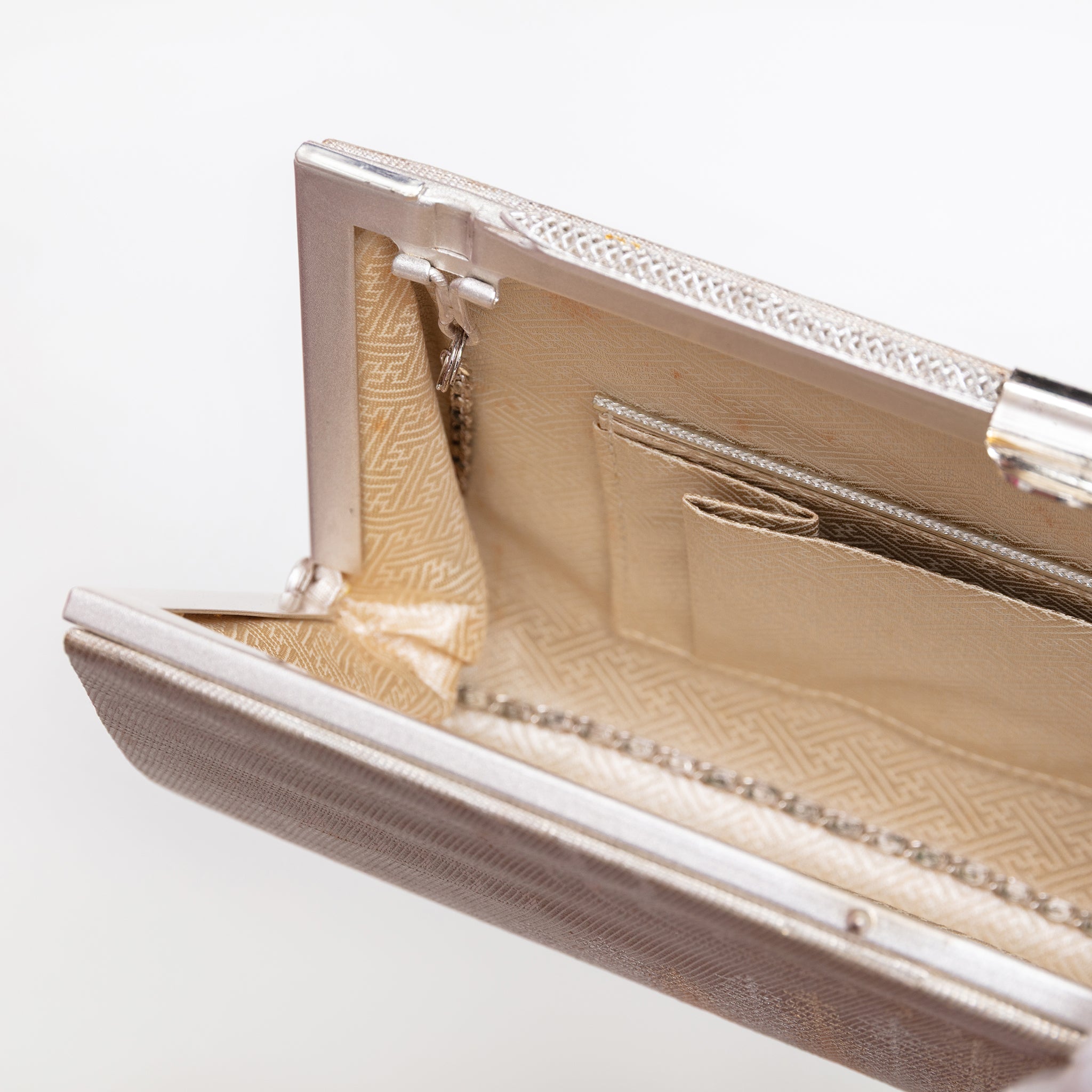 Pale gold sayagata silk lining with interior pockets inside vintage Japanese clutch bag