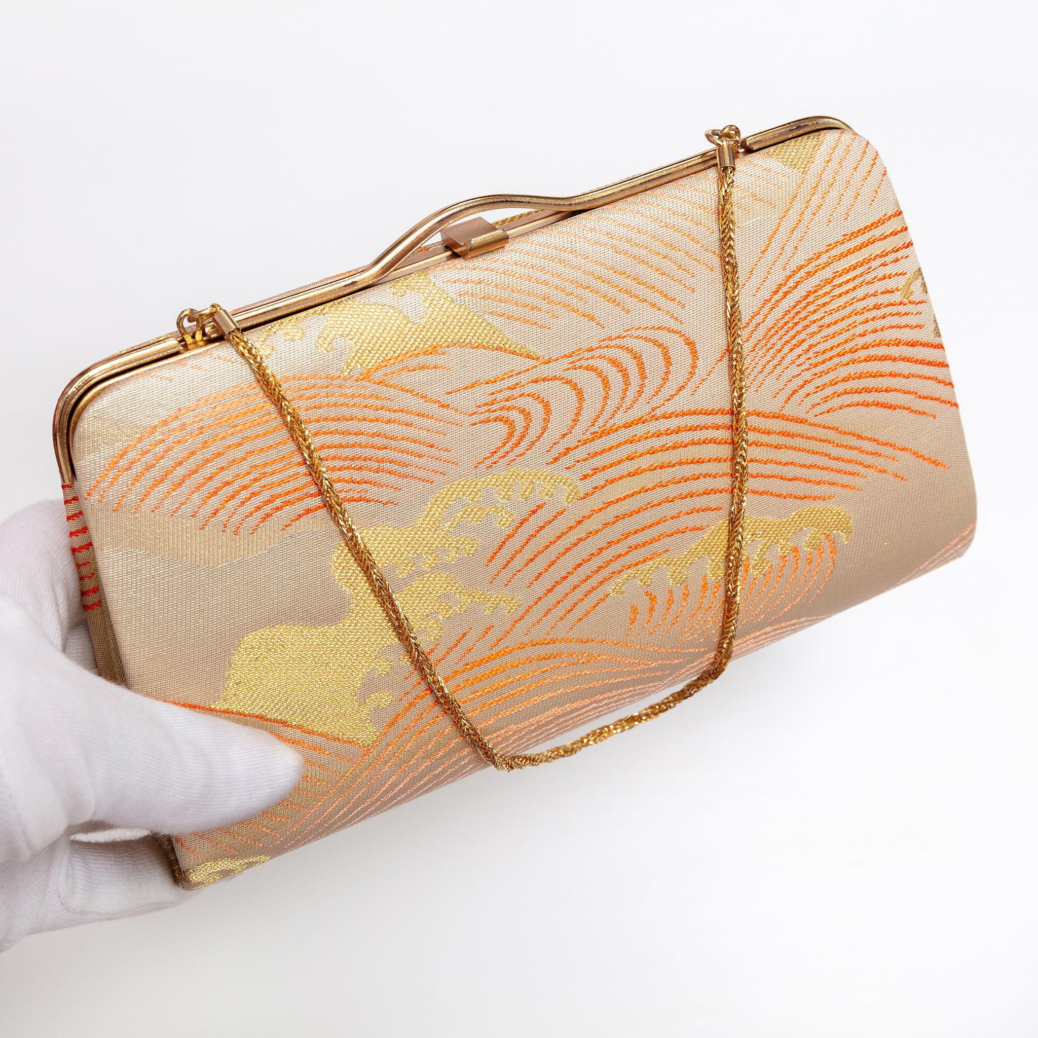 Japanese kimono silk clutch bag with gold-tone frame shown at an angle with gold chain strap