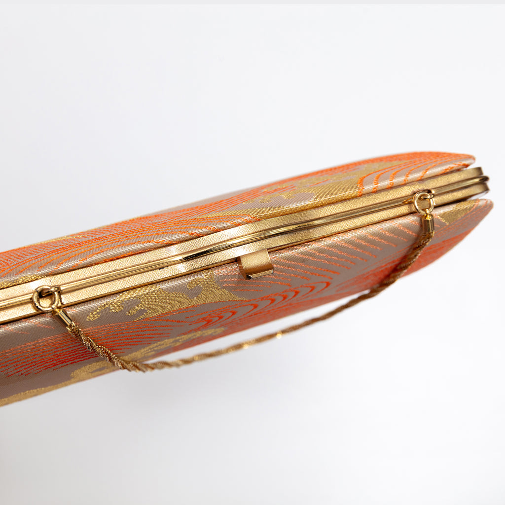 Gold-tone clasp and frame on vintage Japanese clutch bag, araumi design, gold chain strap. orange and gold silk