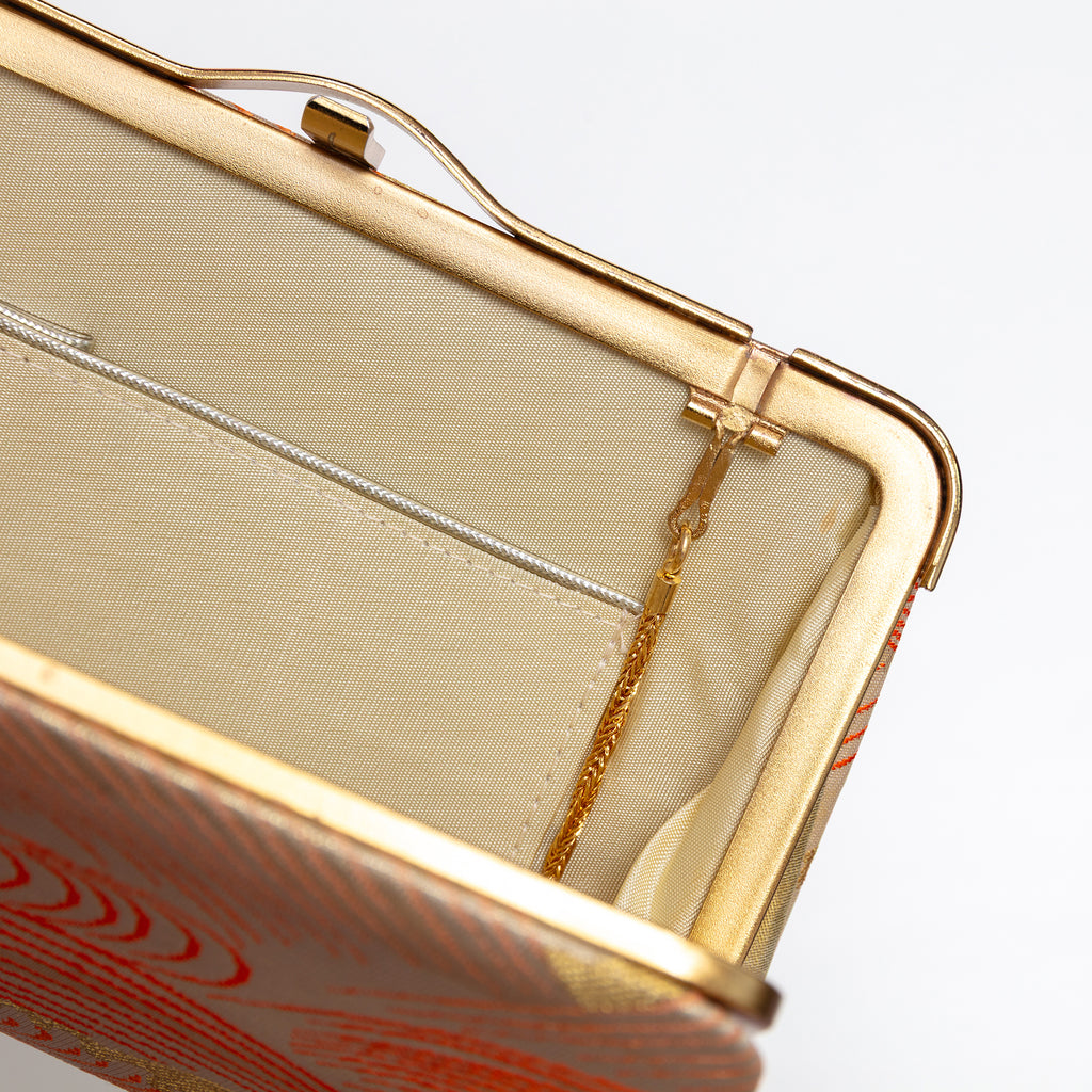 Open vintage Japanese silk clutch bag with cream silk interior and tuck away strap hinges.