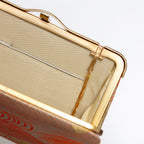 Open vintage Japanese silk clutch bag with cream silk interior and tuck away strap hinges.