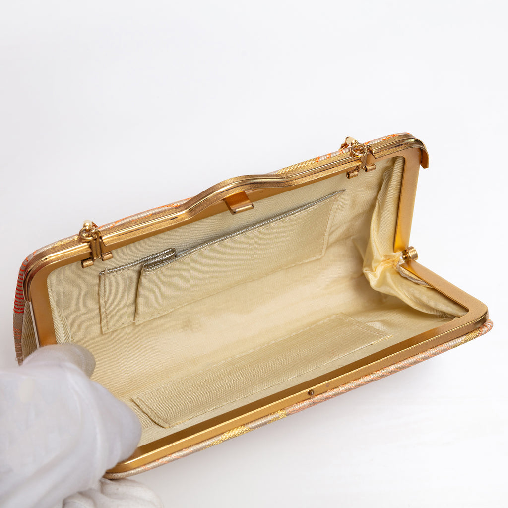 Open vintage Japanese silk clutch bag with cream silk interior, chain strap hinges deployed
