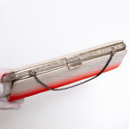 Top view of silver-tone clasp, textured silver frame and chain strap on vintage Japanese silk clutch