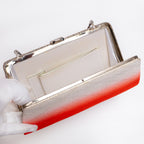 Open vintage Japanese silk clutch with white silk lining with one interior pocket showing with silver trim