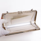 Open vintage Japanese silk clutch bag with silver-tone chain extended. White silk lining and two interior pockets