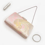 Iridescent metallic pink, gold and silver Japanese kimono silk clutch bag with phoenix design, shown in styled flatlay