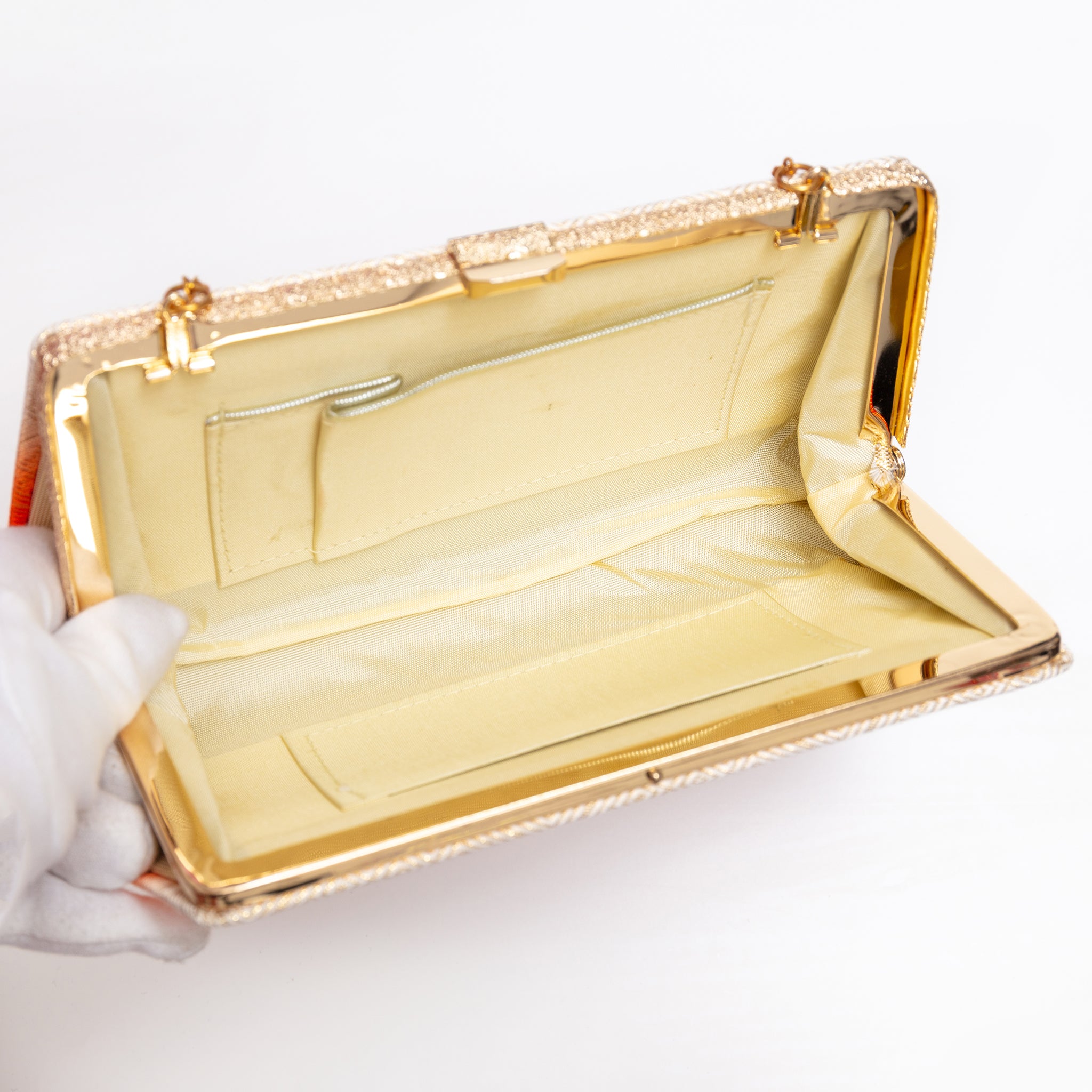 Open vintage Japanese silk clutch bag with gold-tone chain extended. View of internal pockets and cream silk lining.