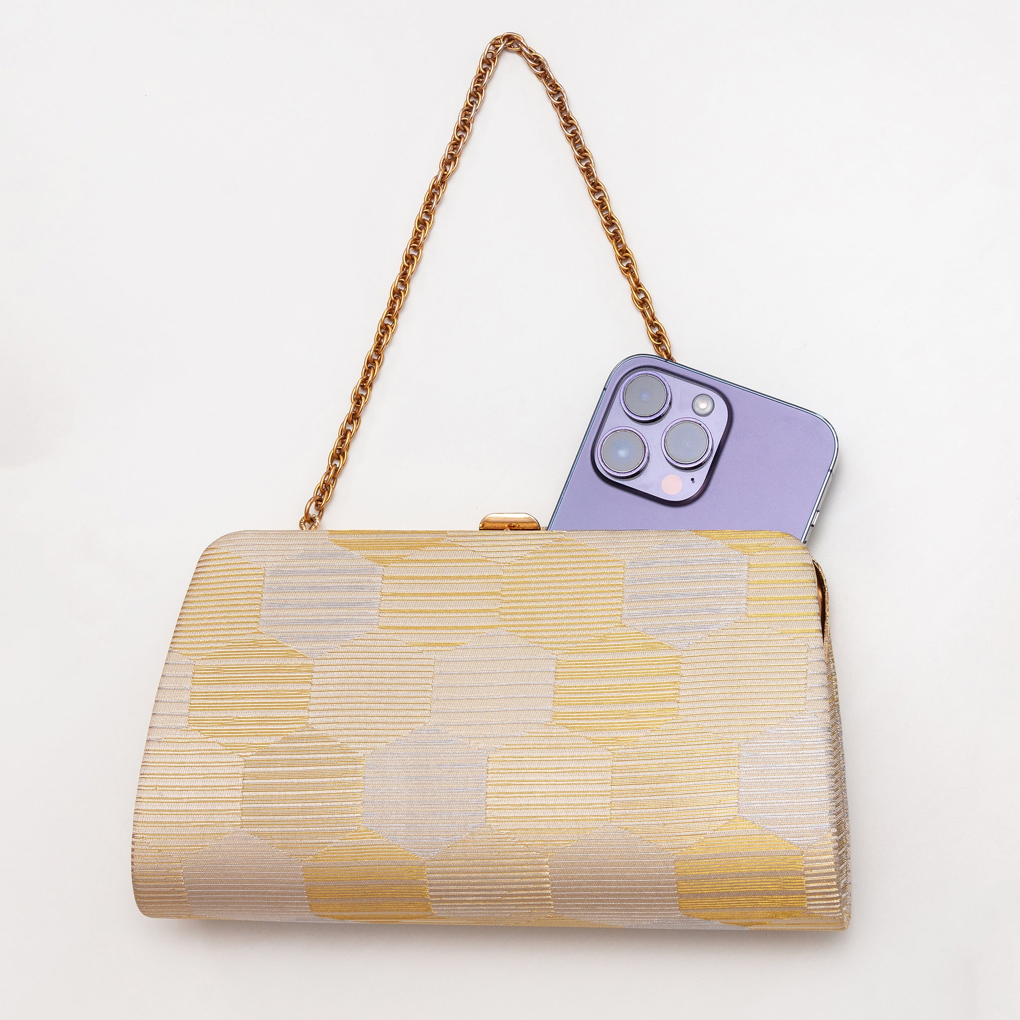 Gold and silver Japanese kimono silk clutch bag shown with iPhone 14 Pro Max for scale