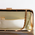 Close-up of fold-away chain hinge inside gold-tone metal frame
