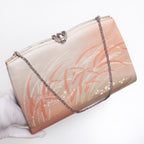 Windswept grass vintage kimono silk clutch bag held at three-quarter view with silver-tone chain extended and fancy silver clasp.