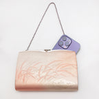 Metallic peach and gold Japanese silk clutch bag shown with iPhone 14 Pro Max for scale