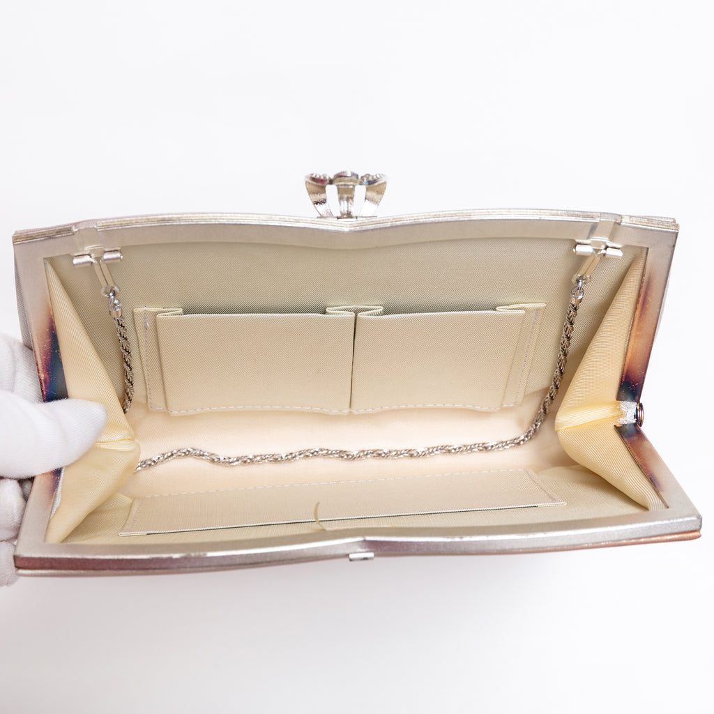 Open vintage Japanese silk clutch bag with silver-tone chain tucked inside, cream silk lining and 3 interior pockets.
