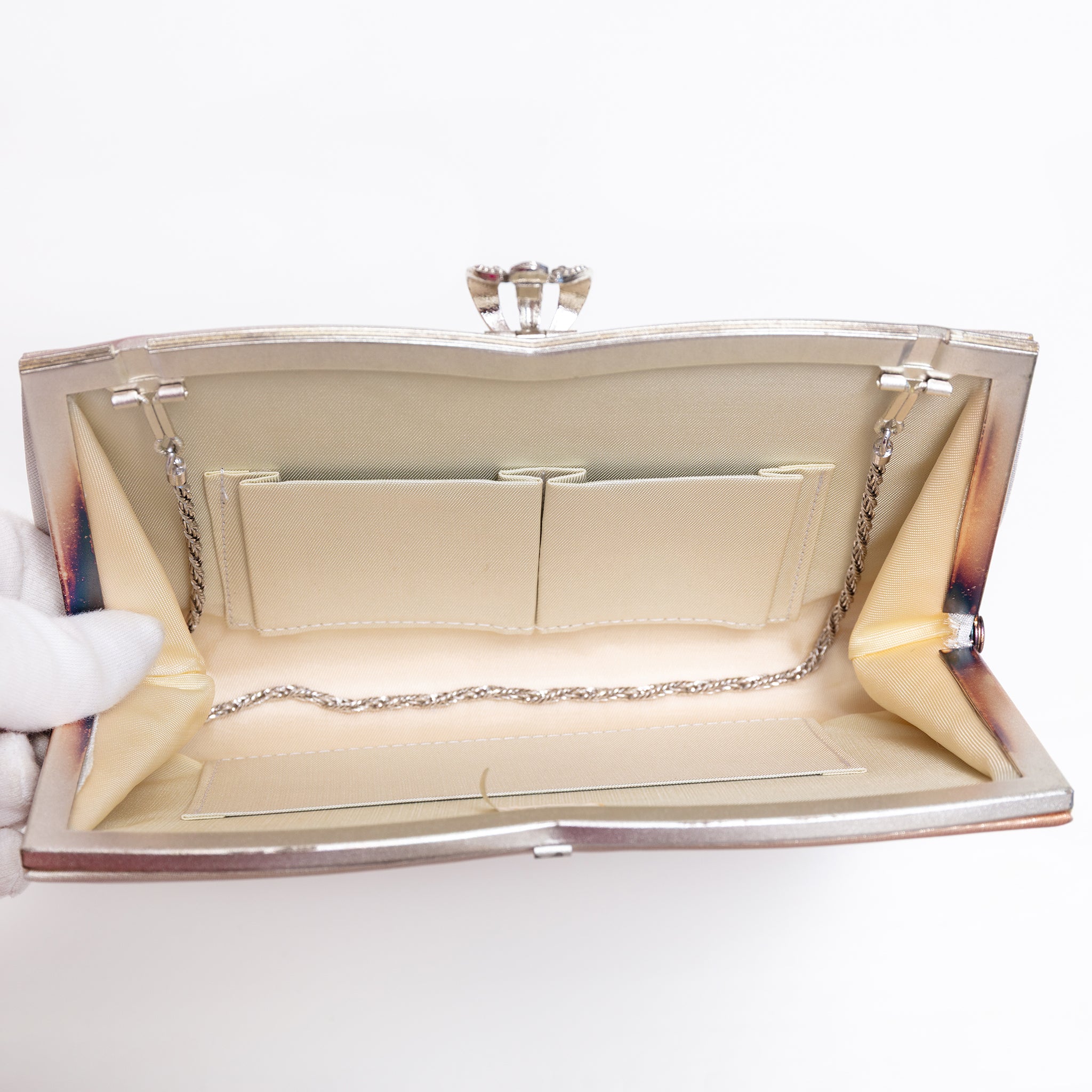 Open vintage Japanese silk clutch bag with silver-tone chain tucked inside, cream silk lining and 3 interior pockets.