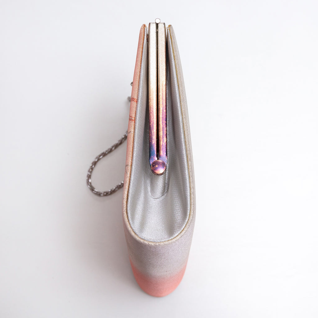 Side view of metallic peach and silver Japanese kimono silk clutch bag showing rainbow-toned tarnish to the frame and silver silk side panel, silver chain strap.