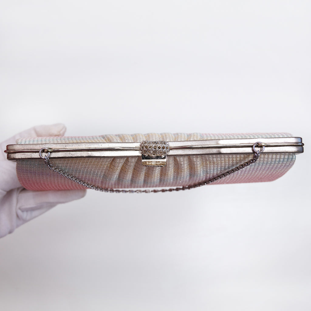 Top view of silver-tone filigree clasp and decorative metal frame