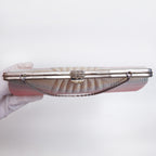 Top view of silver-tone filigree clasp and decorative metal frame