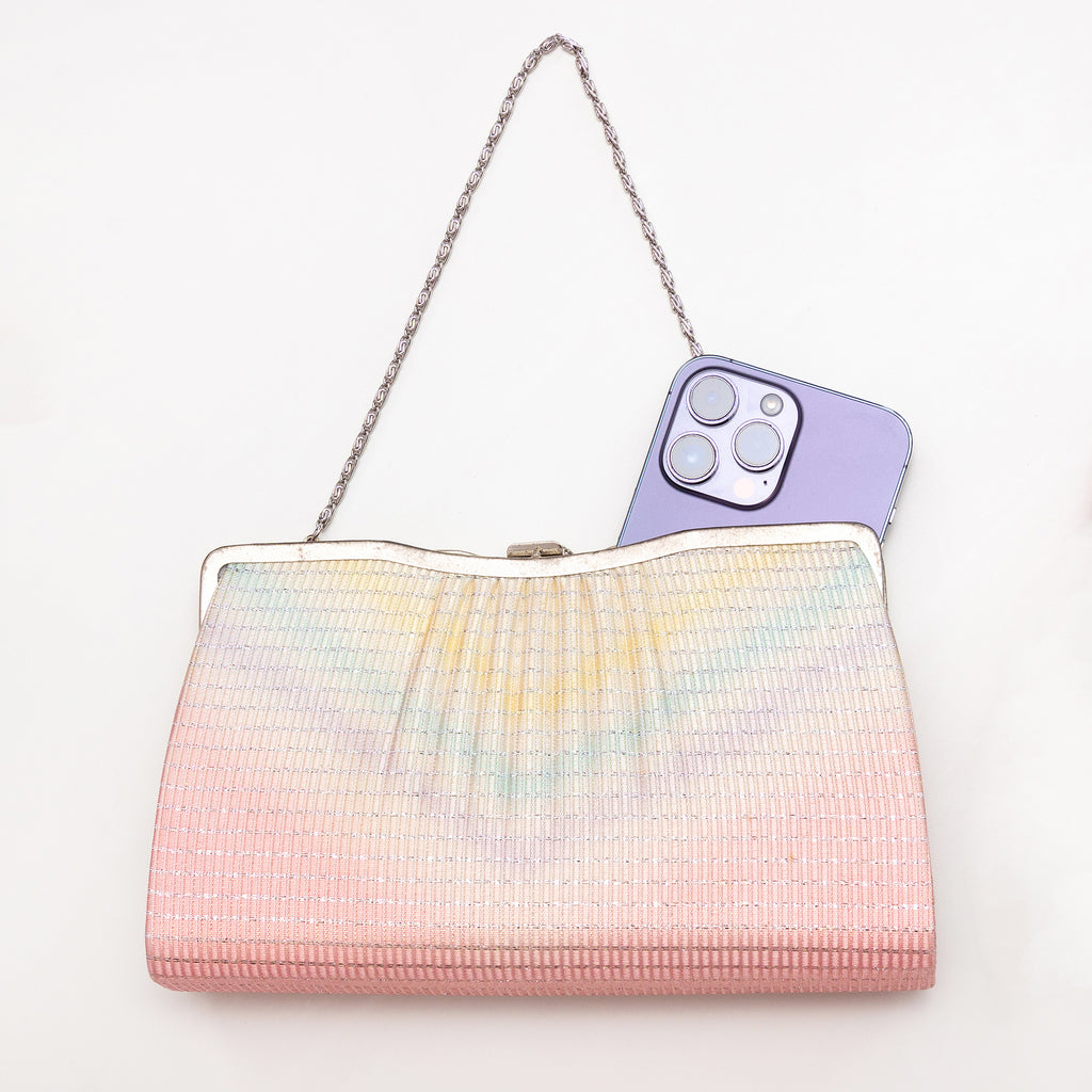 Pastel rainbow Japanese silk clutch bag shown with iPhone 14 Pro Max for scale
